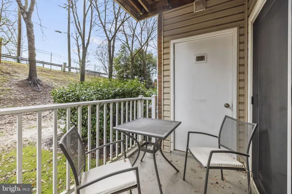 a view of a chair and table in the balcony