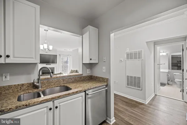 a kitchen with sink and cabinets