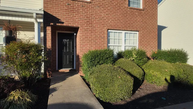 a view of a house with a small yard