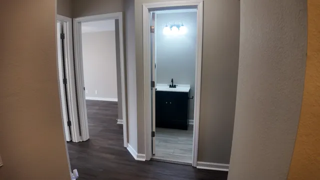 a view of a bathroom from a hallway