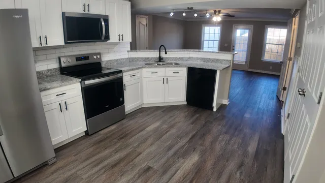 a kitchen with a sink and a stove top oven