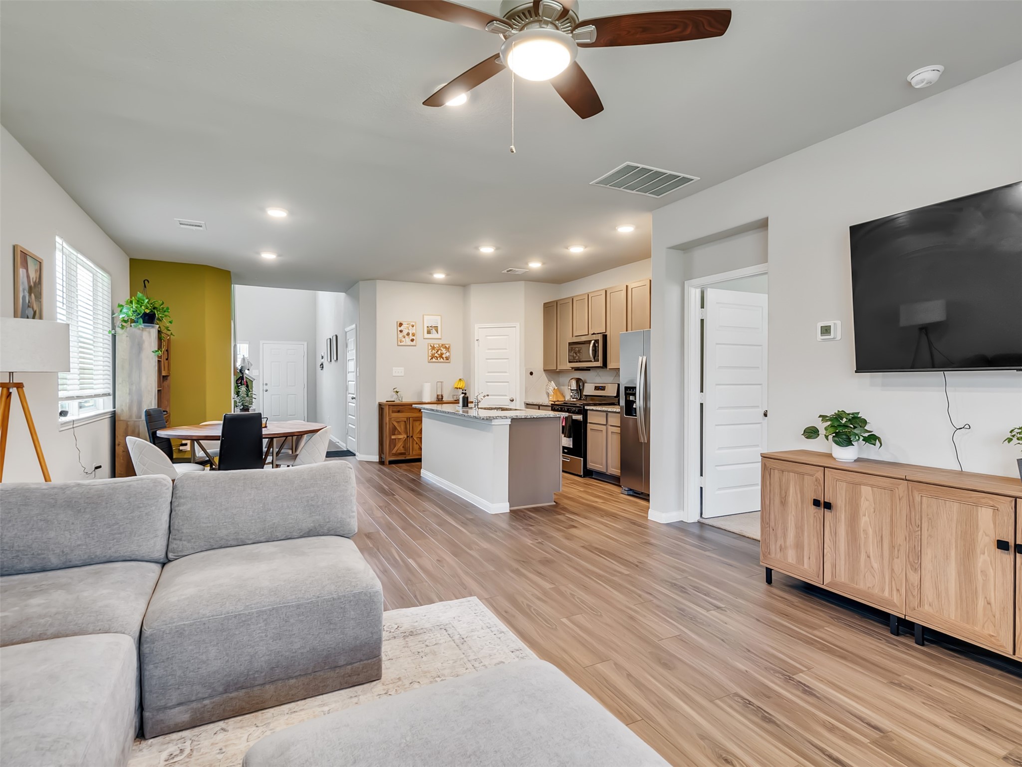 2416 Bluefish Court Conroe, TX 77384 - Photo 32 of 45 a living room with furniture kitchen view and a flat screen tv