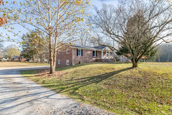 a view of house with outdoor space and garden