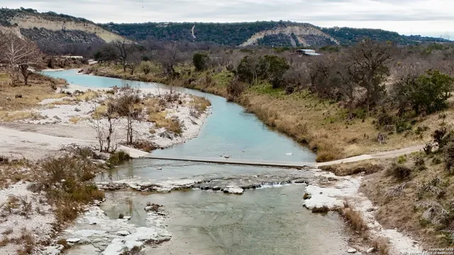 a view of a yard with wooden fence