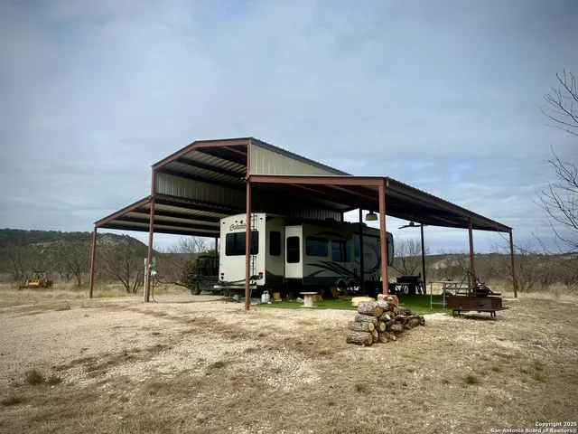 an aerial view of house with yard and mountain view in back