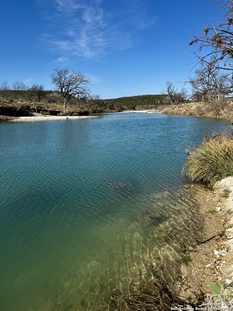 410 Craig Lane Junction, TX 76849 - Photo 43 of 53 a view of a lake with houses in the back