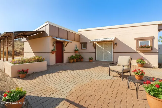 a view of a terrace with chairs and potted plants