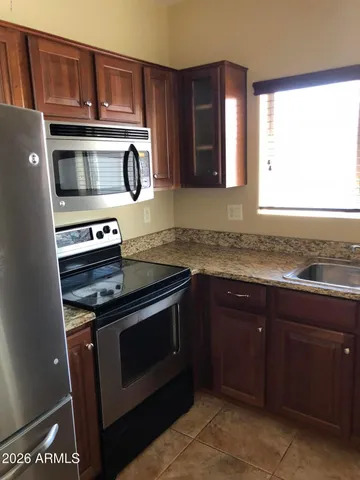 a kitchen with stainless steel appliances granite countertop a stove and a microwave