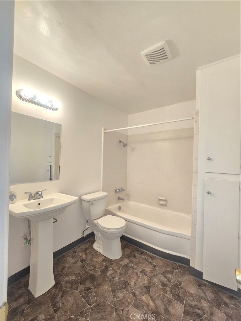540 East 7th Street, Unit E Upland, CA 91786 - Photo 7 of 9 a bathroom with a toilet a sink and bathtub