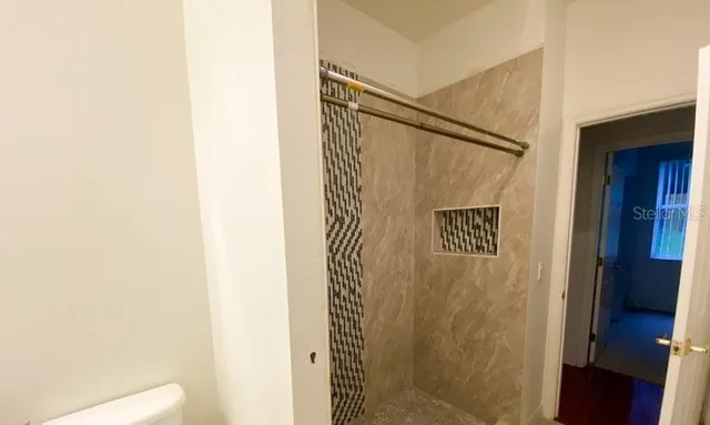 a bathroom with a shower and a sink