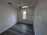 596 Neumann Village Court Ocoee, FL 34761 - Photo 11 of 25 an empty room with wooden floor and windows