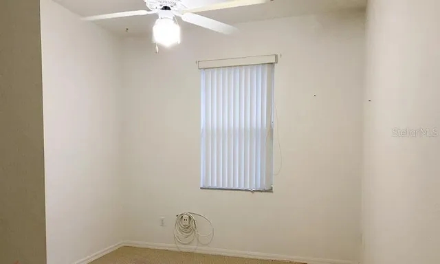a bathroom with a window and a fan