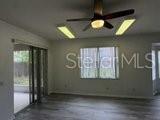 596 Neumann Village Court Ocoee, FL 34761 - Photo 2 of 25 wooden floor in an empty room with a window