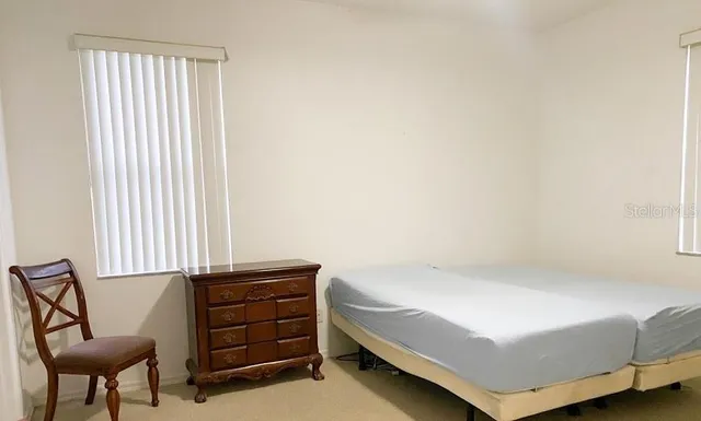 a bedroom with a bed and chair