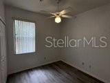 596 Neumann Village Court Ocoee, FL 34761 - Photo 9 of 25 a view of wooden floor and windows in a room