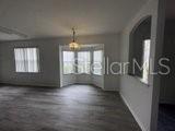 596 Neumann Village Court Ocoee, FL 34761 - Photo 10 of 25 wooden floor in an empty room with a window