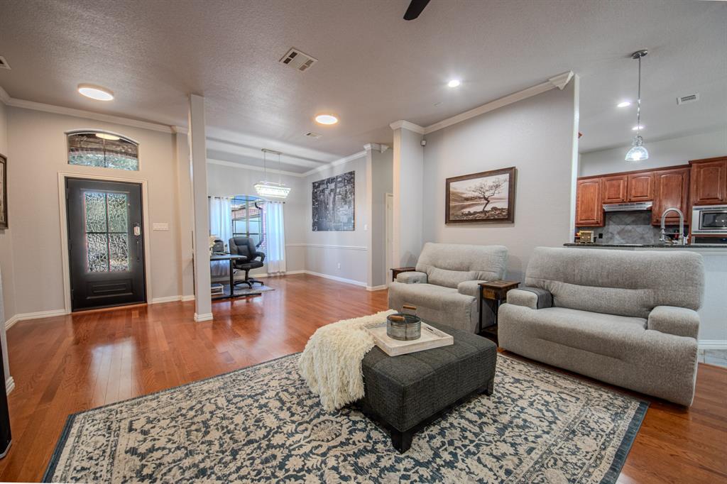 9001 Ravenswood Road Granbury, TX 76049 - Photo 12 of 38 Living room featuring wood finished floors, ornamental molding, recessed lighting, and a ceiling fan