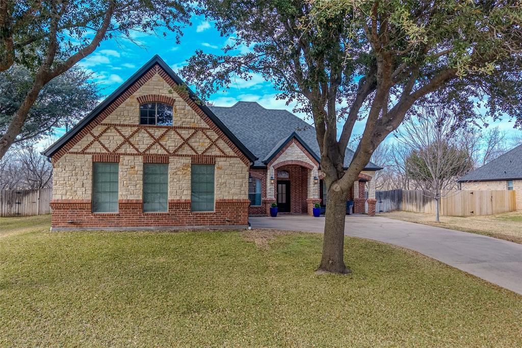 9001 Ravenswood Road Granbury, TX 76049 - Photo 4 of 38 Tudor home with stone siding, concrete driveway, and brick siding