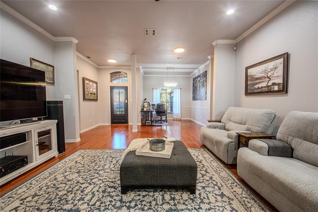 9001 Ravenswood Road Granbury, TX 76049 - Photo 7 of 38 Living room featuring wood finished floors, ornamental molding, and recessed lighting