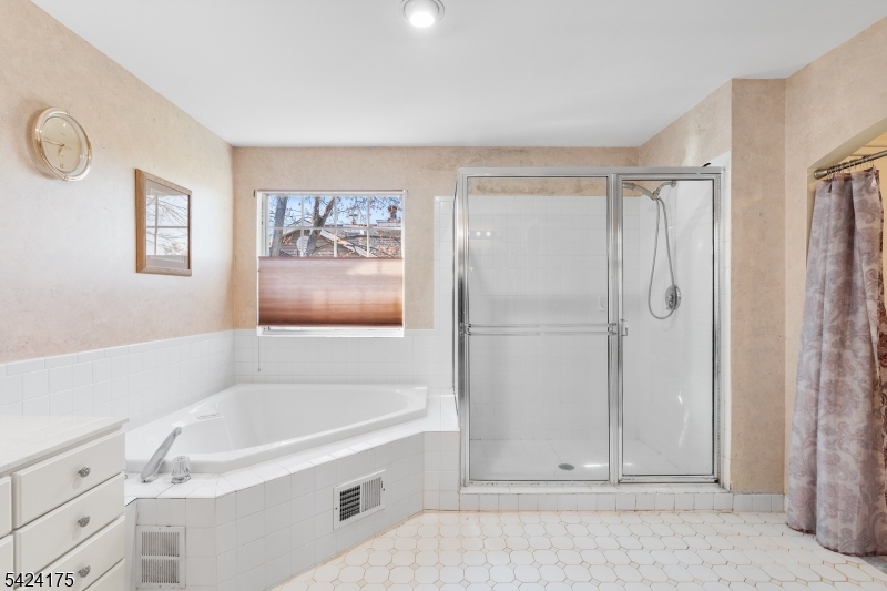 70 Hartley Lane Bernards, NJ 07920 - Photo 18 of 33 a bathroom with a tub and a shower