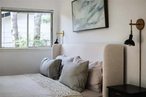 a large bed with a black white comforter