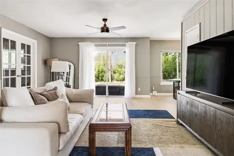 a dining room with furniture and a potted plant