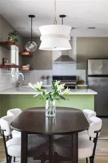 a dining room with furniture and a potted plant