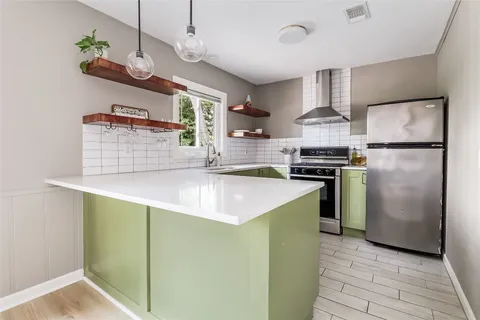 a kitchen with a sink and wooden cabinets