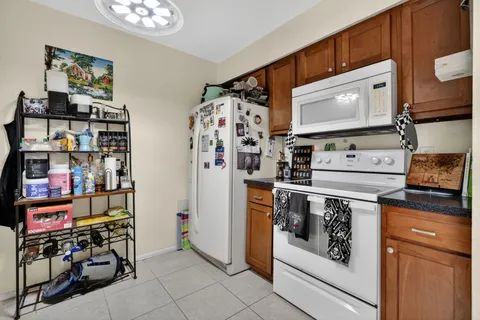 a utility room with stainless steel appliances a stove and a refrigerator