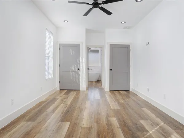 wooden floor in an empty room with a window