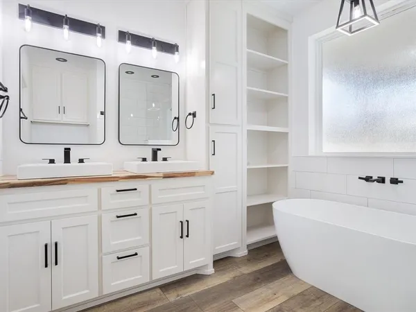 a white bath tub sitting in a bathroom and shower