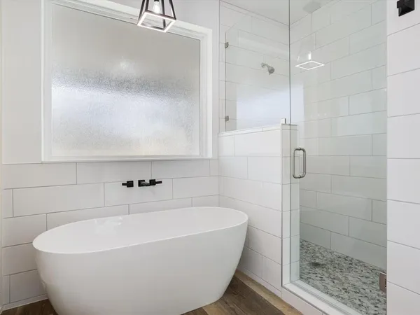 a bathroom with a bathtub and a sink