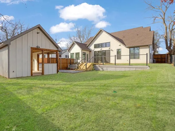 a view of a house with a yard and porch