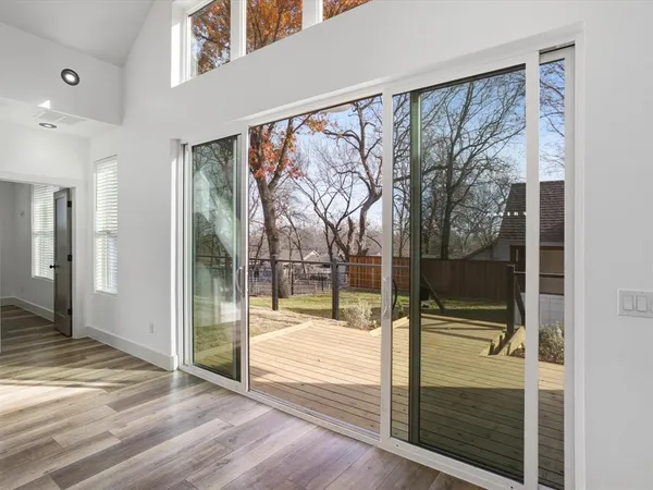 a large kitchen with stainless steel appliances kitchen island granite countertop a refrigerator and a sink