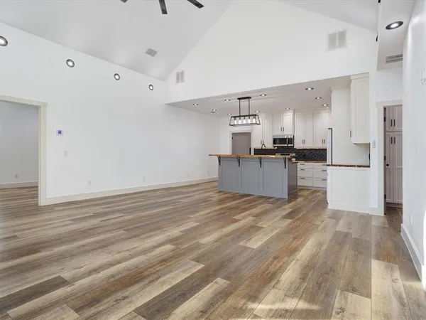 a kitchen with stainless steel appliances granite countertop a stove a sink and a refrigerator