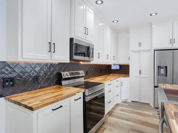 a kitchen with a sink stove and refrigerator