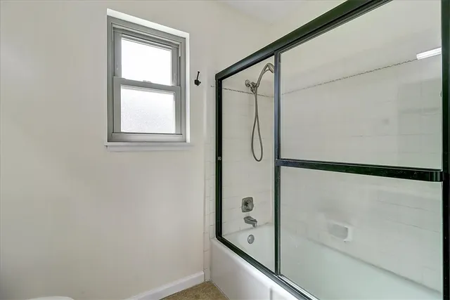 a bathroom with a glass shower door