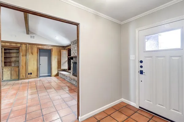 a view of an empty room with window and bathroom