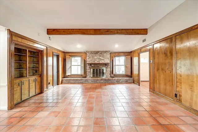 a view of an entryway with a floor to ceiling window and an empty room