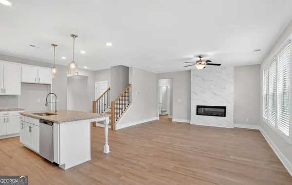 a view of a kitchen with a sink and a fireplace