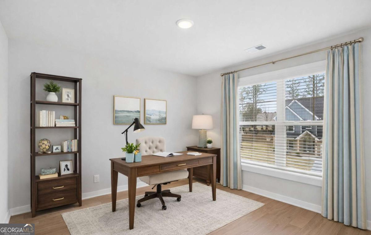 136 Patillo Manor, Unit 9 Stockbridge, GA 30281 - Photo 6 of 18 a workspace with furniture and window