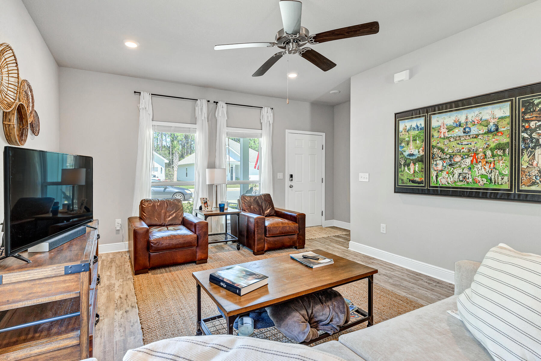 186 Southern Pnes Road Santa Rosa Beach, FL 32459 - Photo 6 of 32 a living room with furniture a flat screen tv and a large window