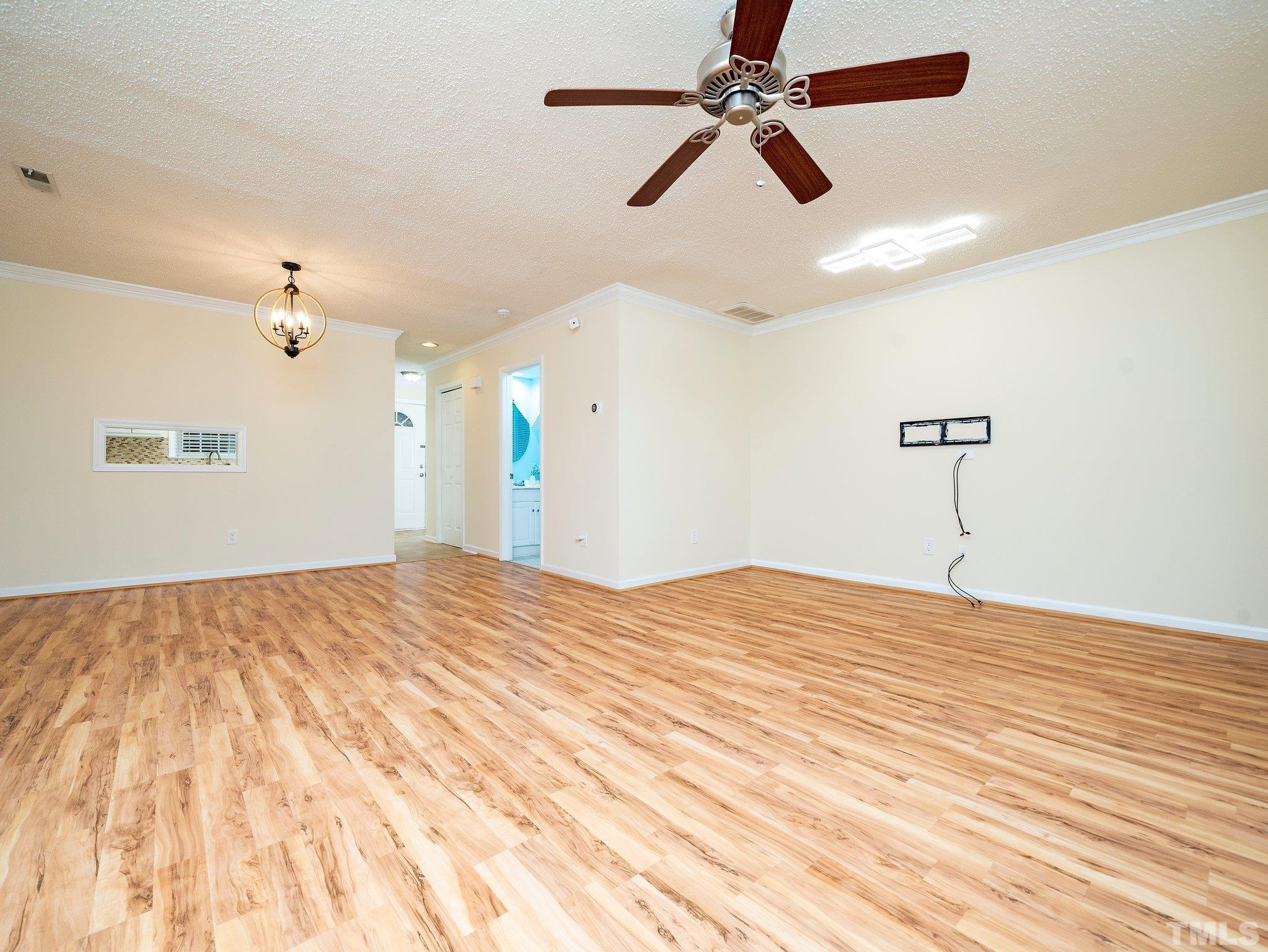 5632 Bridgetowne Way Raleigh, NC 27609 - Photo 11 of 26 a bedroom with a bed and a chandelier