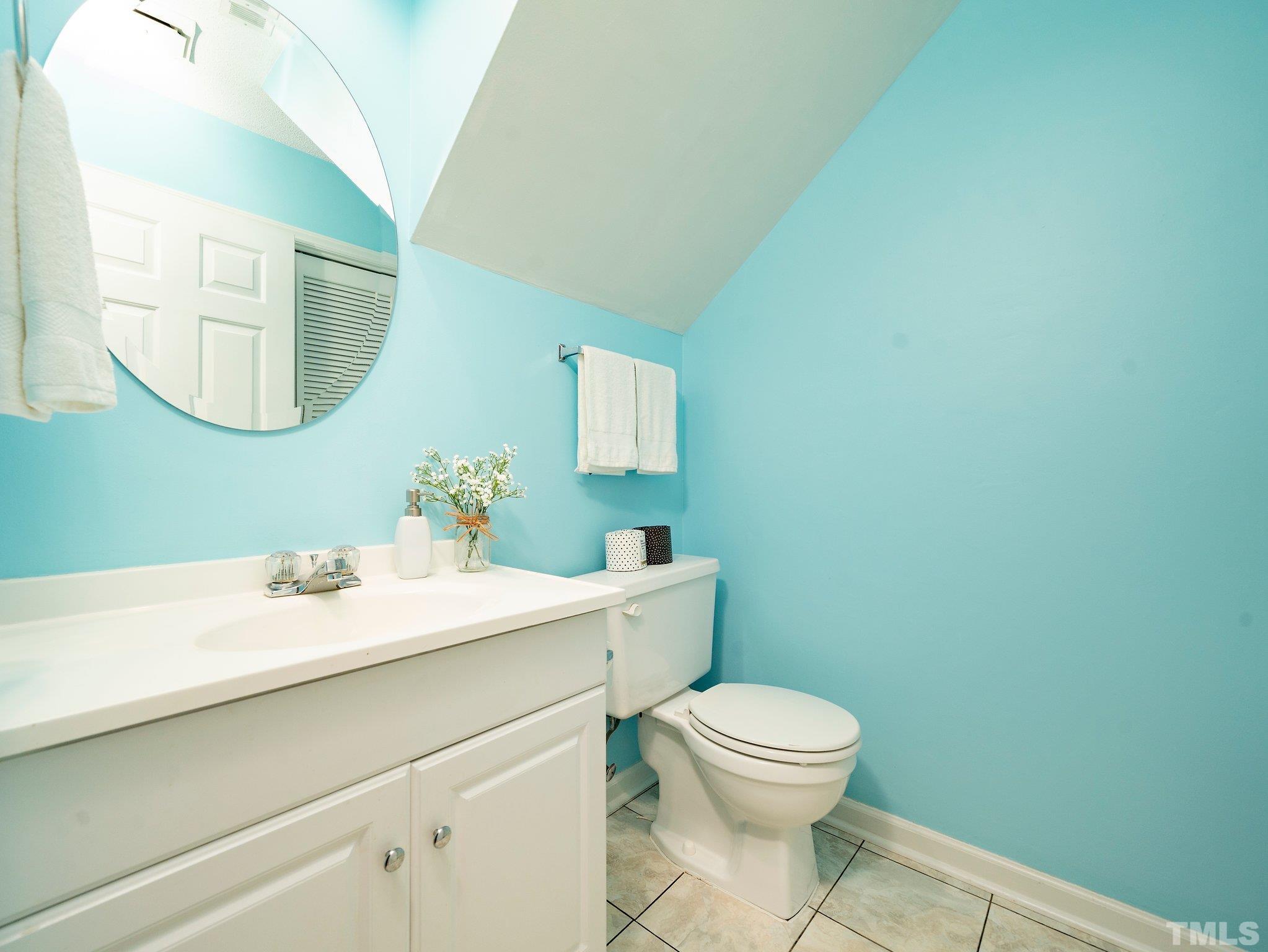 5632 Bridgetowne Way Raleigh, NC 27609 - Photo 12 of 26 a bathroom with a toilet a sink and mirror