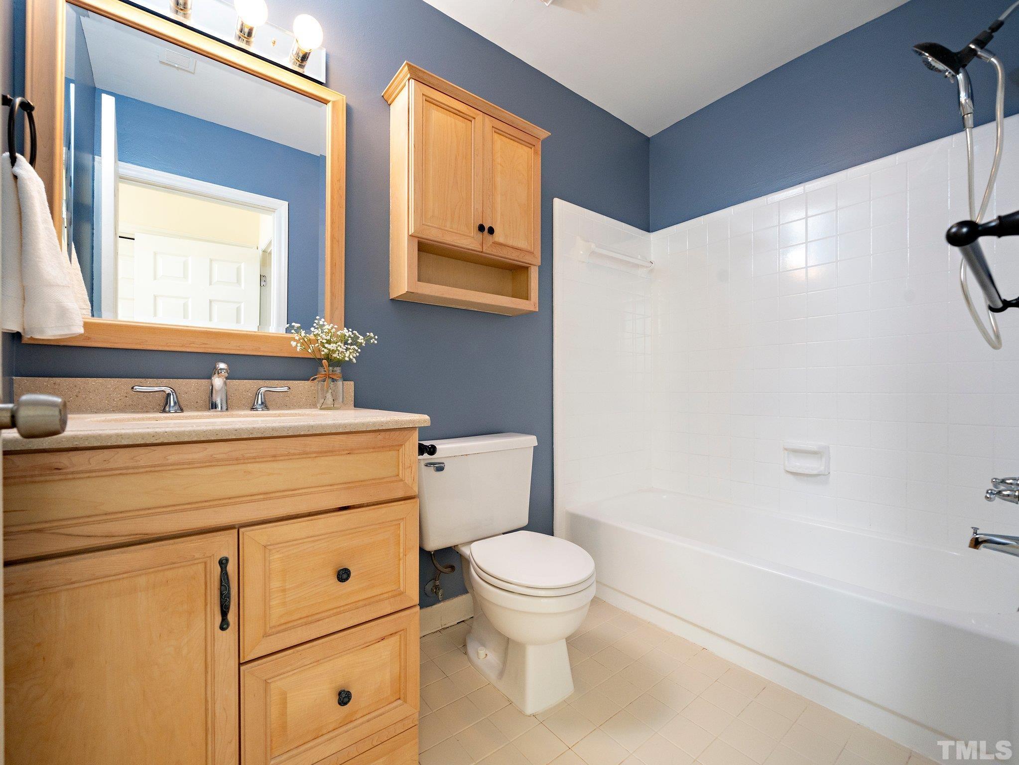 5632 Bridgetowne Way Raleigh, NC 27609 - Photo 15 of 26 a bathroom with a sink a toilet and a bathtub