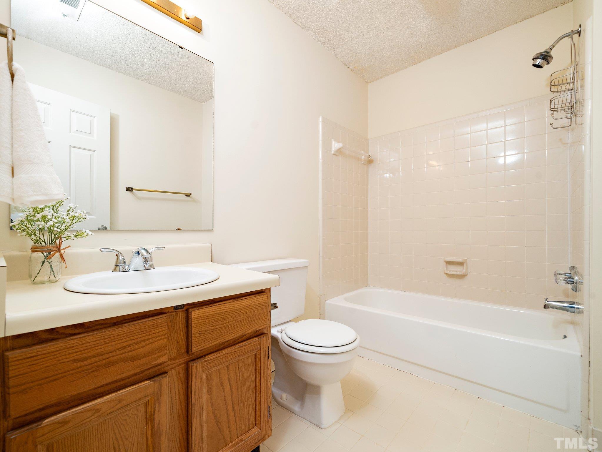 5632 Bridgetowne Way Raleigh, NC 27609 - Photo 17 of 26 a bathroom with a sink a toilet and shower