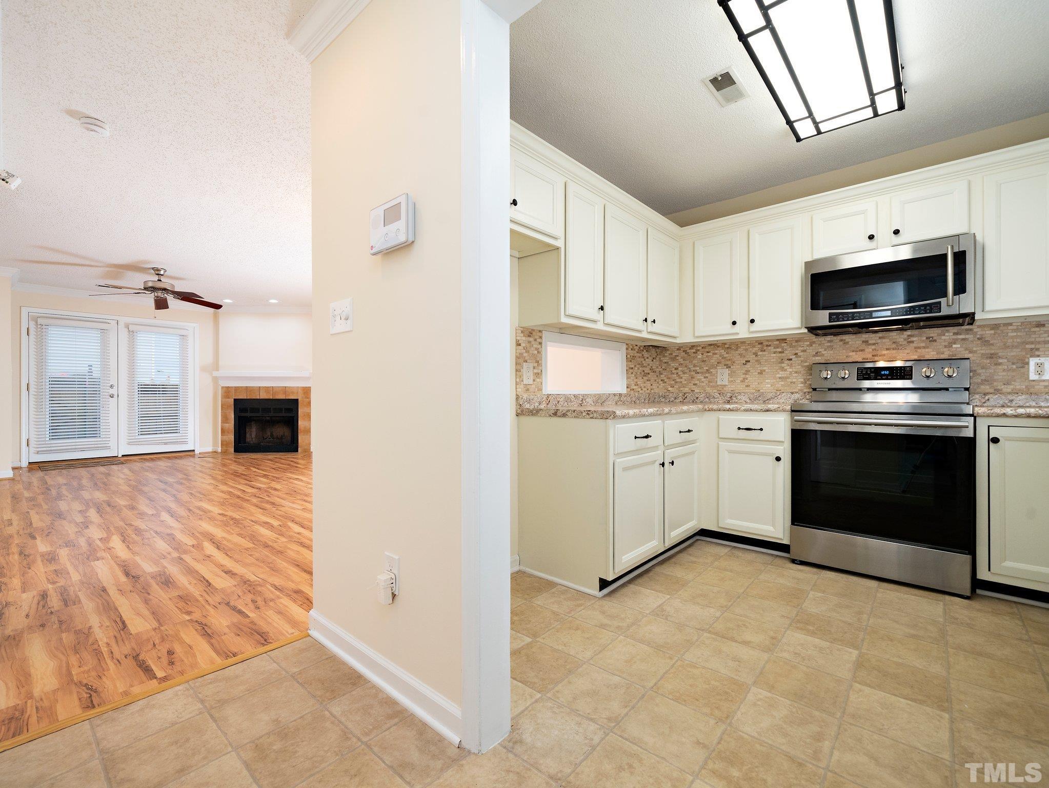5632 Bridgetowne Way Raleigh, NC 27609 - Photo 2 of 26 a kitchen with stainless steel appliances granite countertop a stove a sink and a refrigerator