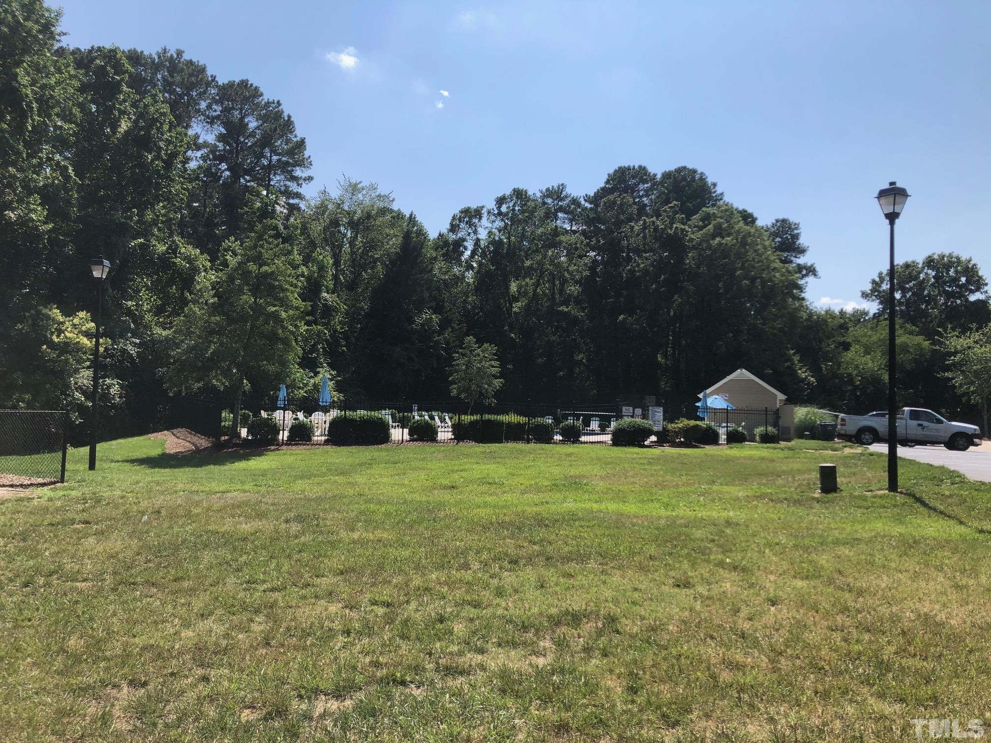 5632 Bridgetowne Way Raleigh, NC 27609 - Photo 24 of 26 a backyard of a house with lots of green space and fountain