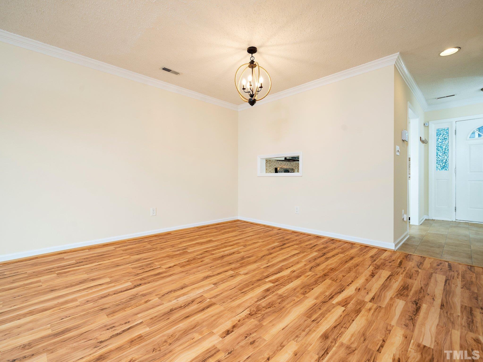 5632 Bridgetowne Way Raleigh, NC 27609 - Photo 6 of 26 a view of a room with wooden floor and a ceiling fan