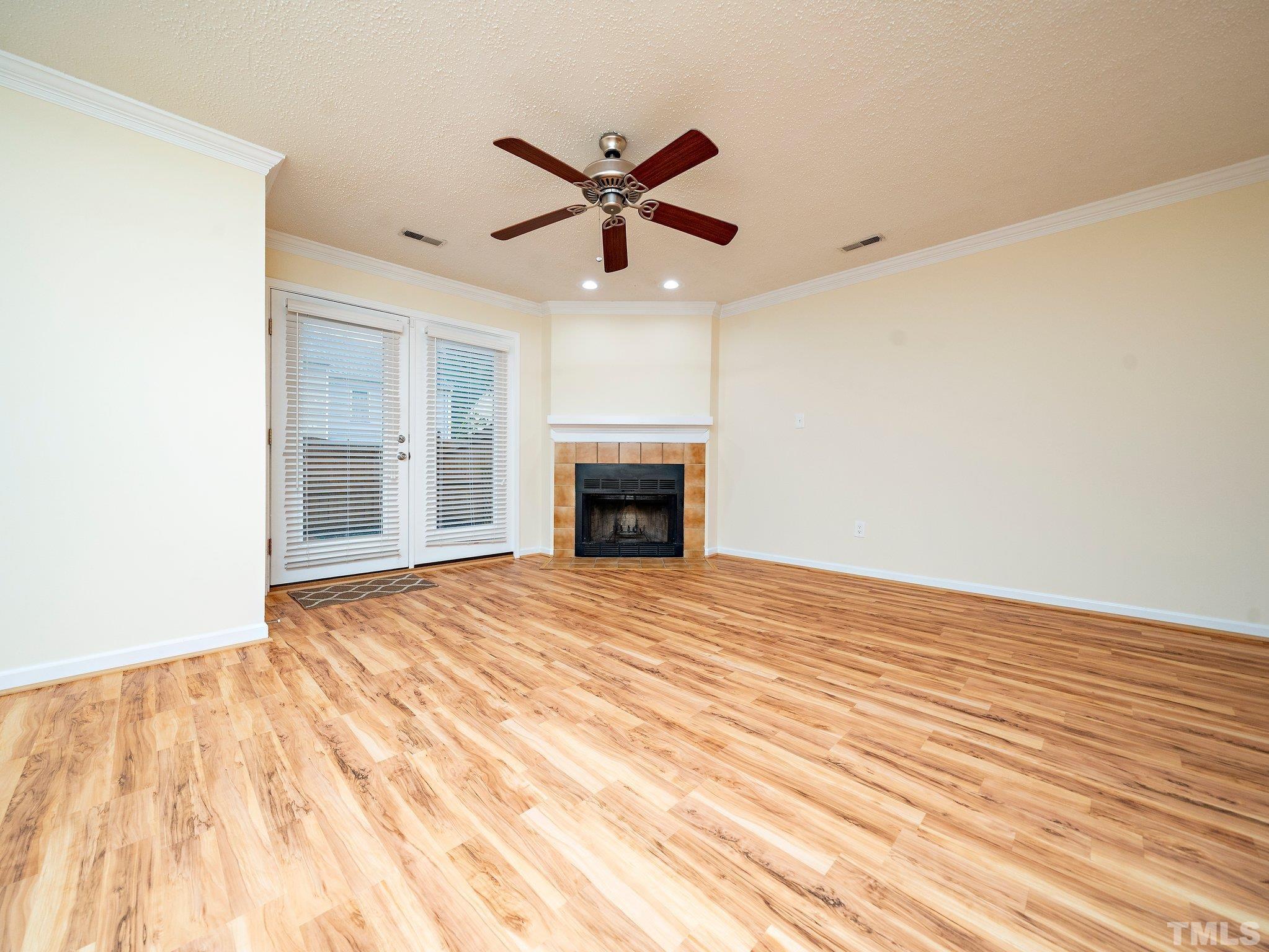 5632 Bridgetowne Way Raleigh, NC 27609 - Photo 9 of 26 a view of empty room with wooden floor and fireplace